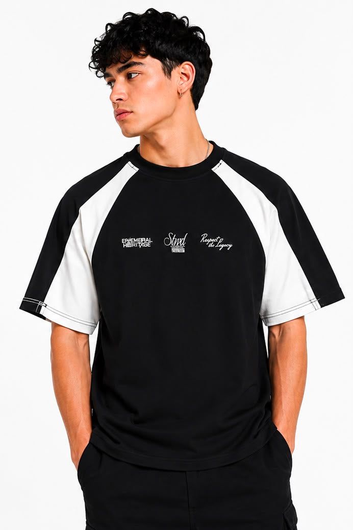 Man wearing a black and white baseball shirt with text on a white background