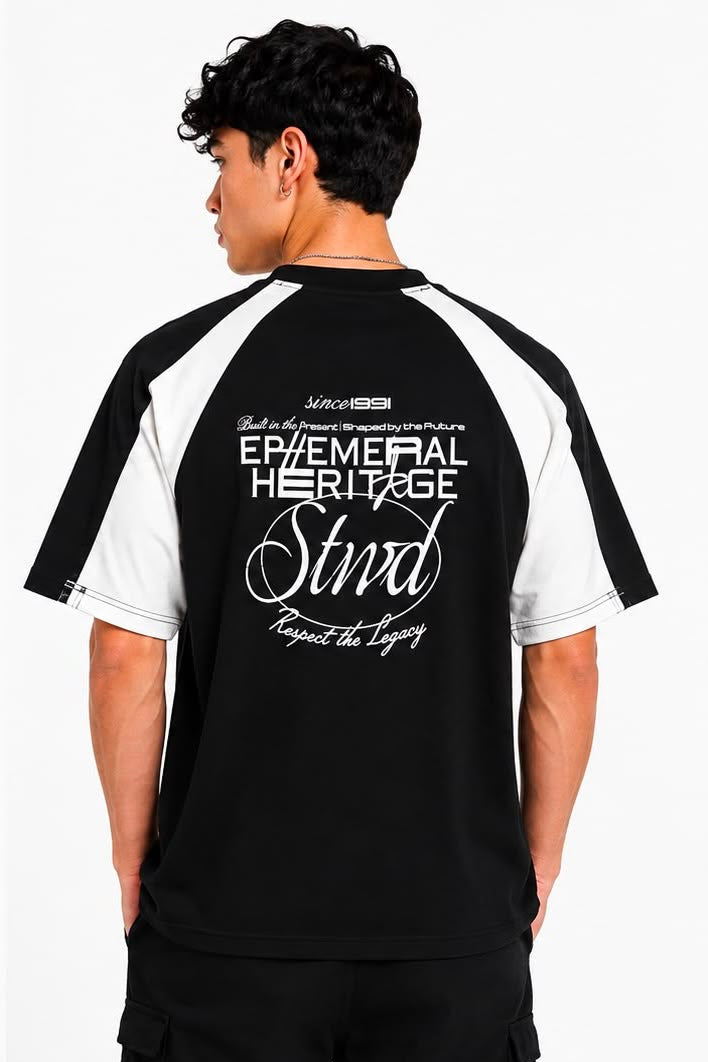 Person wearing a black and white t-shirt with text on the back