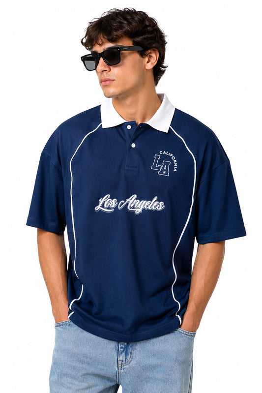 Man wearing a navy blue polo shirt with 'Los Angeles' text and sunglasses on a white background