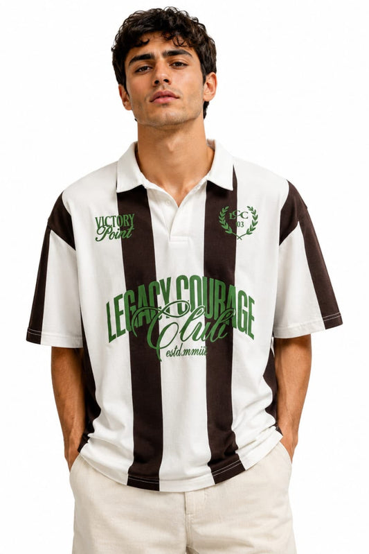 Man wearing a black and white striped polo shirt with green text on a white background