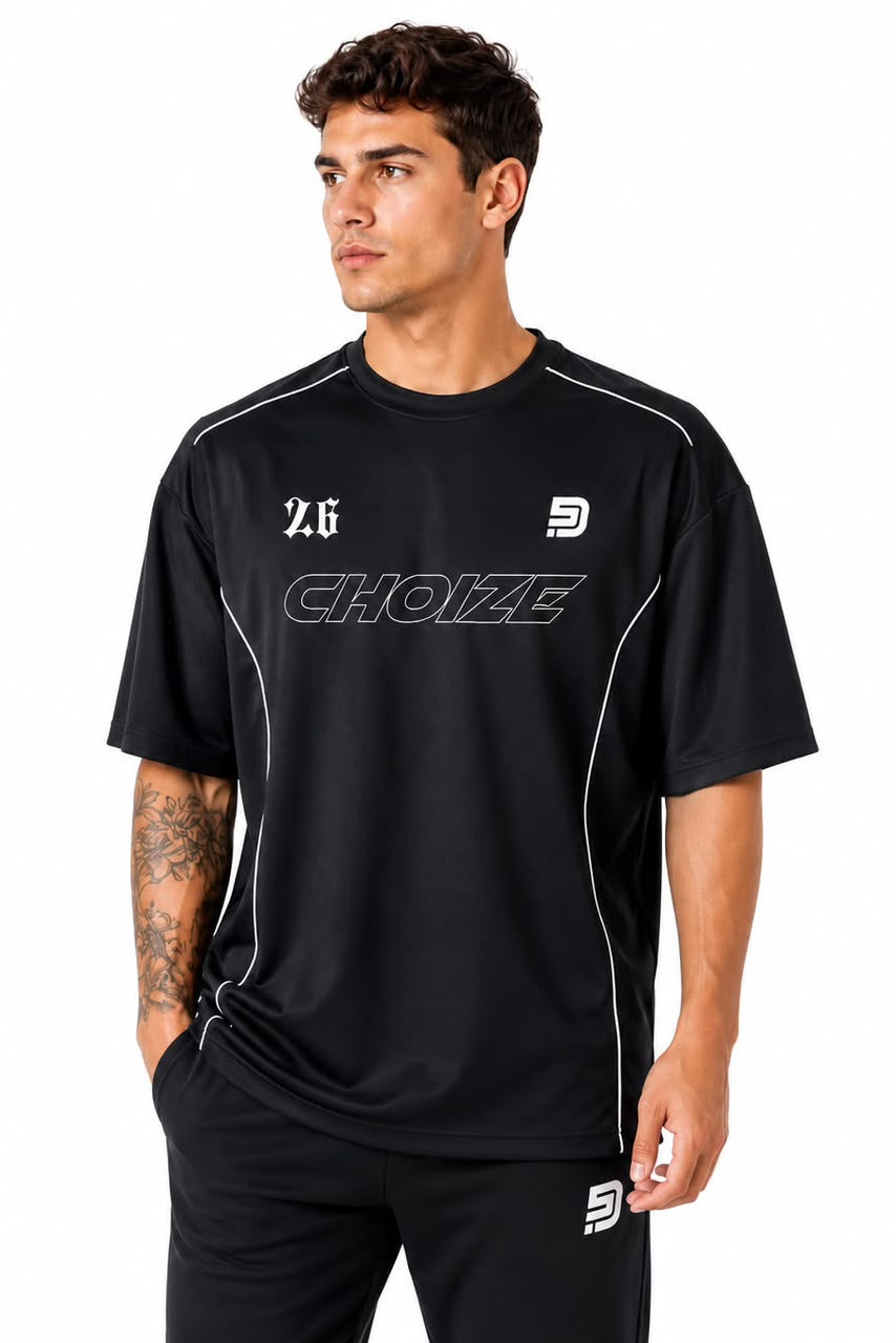 Man wearing a black sports outfit with visible branding on a white background