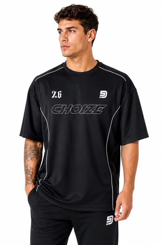 Man wearing a black sports outfit with visible branding on a white background