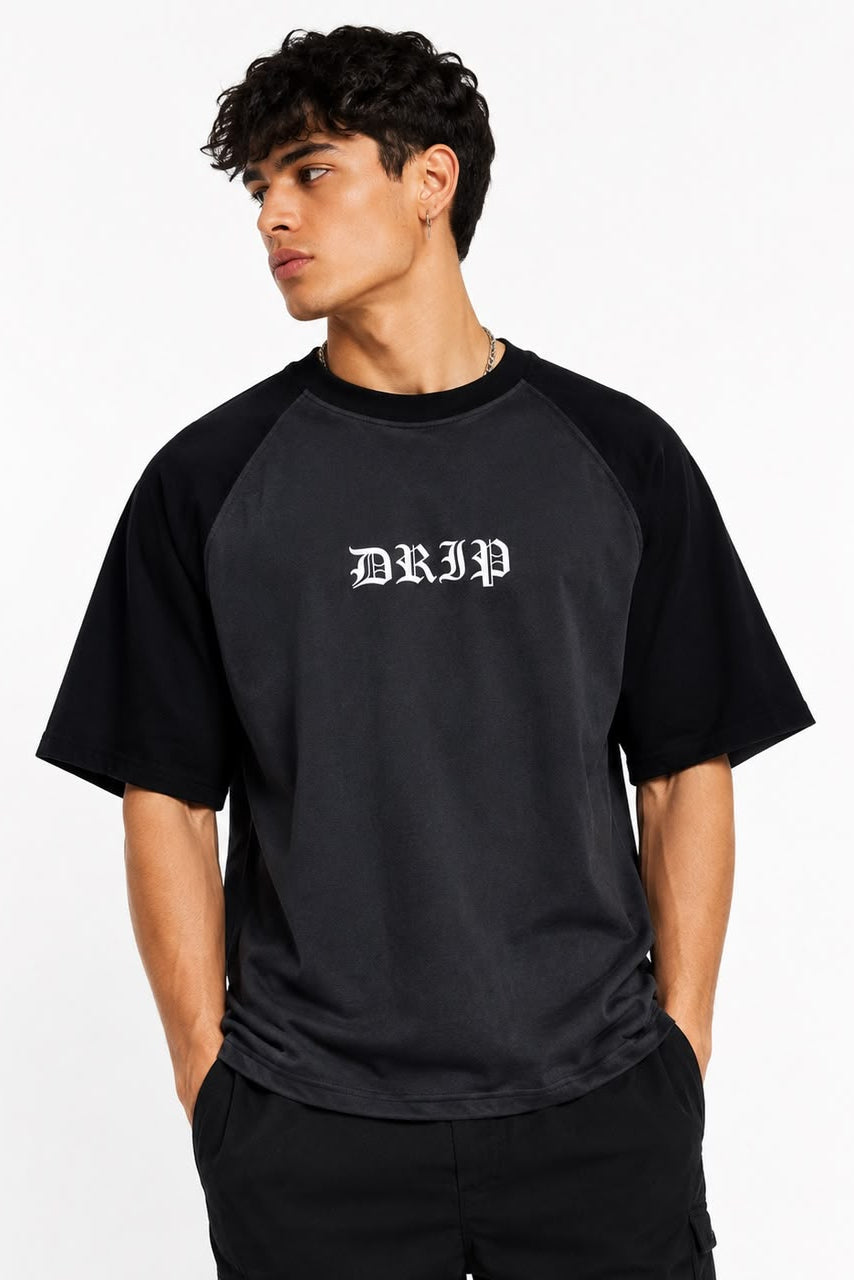 Man wearing a black and gray baseball shirt with 'DRIP' logo on a white background